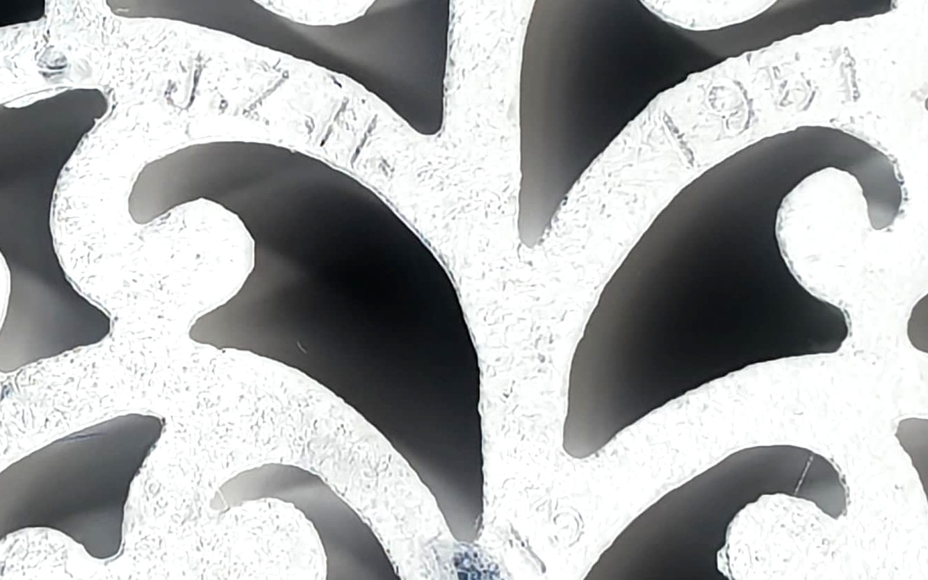 I messed with the contrast in a close-up of the initials and date on the underside of the trivet.